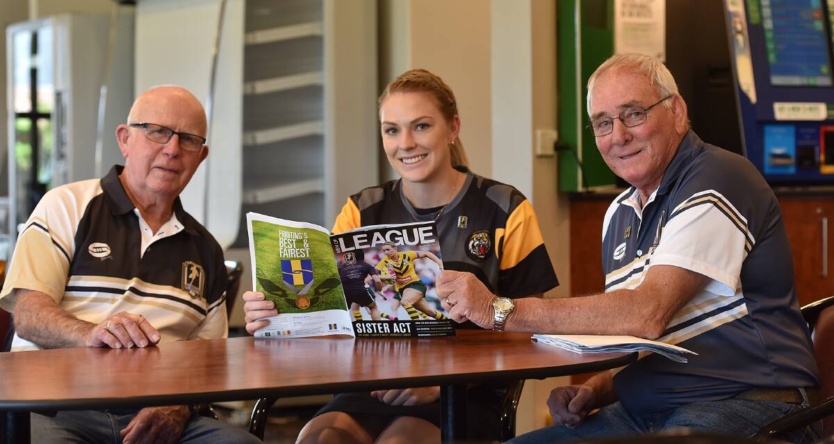 Women of league: Tamworth sub-branch president Kevin Robinson, Kimberley Resch, and Ron Surtees look through a recent edition of the Men of League magazine.
