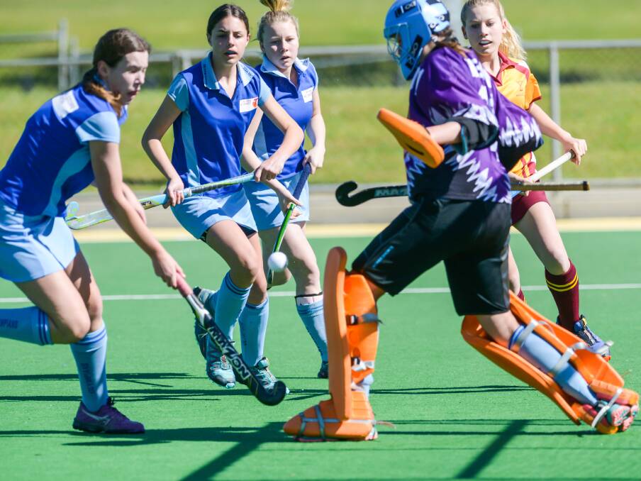 Sticking together: Olympians' Laura Farquhar, Holly Littlejohns and Billie Mitchell combine with keeper Heidi Schimann to stop Millie Sherwood.