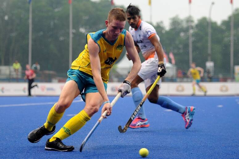 Tamworth's Ehren Hazell spins away from the Indian defence.