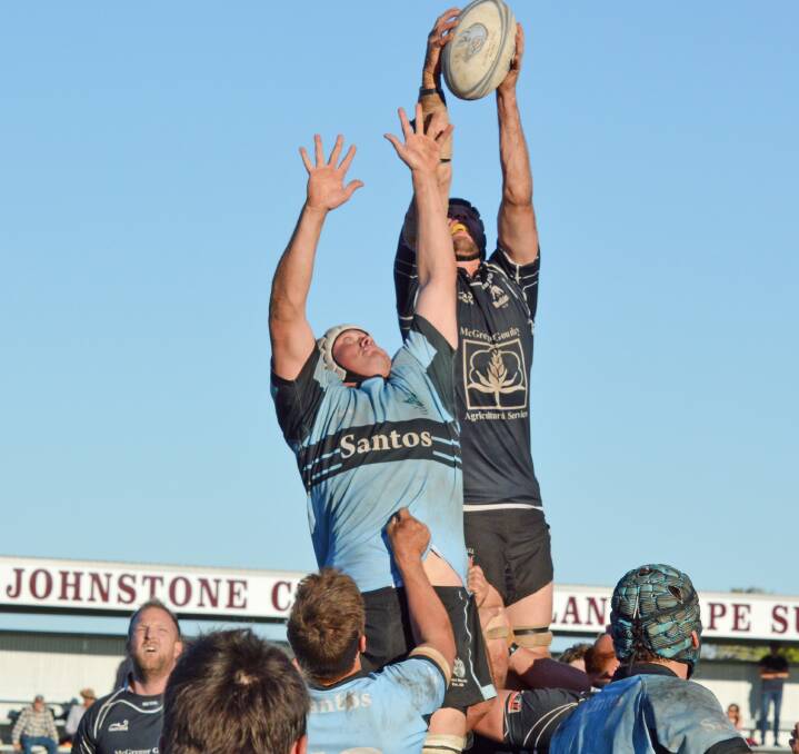 Reaching high: Moree captain-coach Simon Hall gets up in front of Narrabri's Henry Curtin to win this ball during Saturday's enthralling preliminary final, which the Blue Boars won by a point.