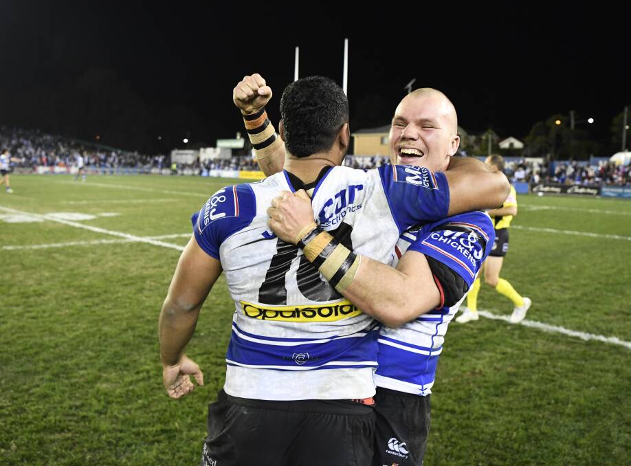 Oh what a feeling: Andy Saunders shares a moment with a Bulldogs team-mate after making his NRL debut in their dramatic two-point win on Sunday.