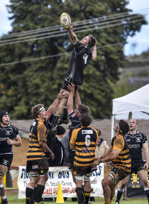 Moree's Fraser Brown is hoisted high during the second grade grand final.