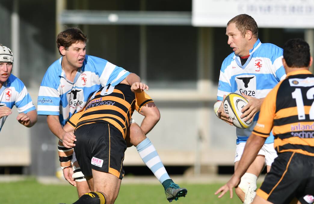 Team-work: Quirindi co-coach Nick Rees offloads to second row partner Richie Hunt against Pirates earlier in the season. Photo: Barry Smith. 210516BSF02