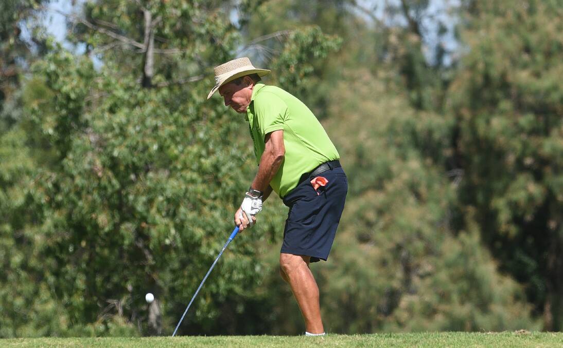 Top shot: Parkwood's Rex Bell chips in during Friday's 4-ball medley. He teamed up with Christine Bell to win the afternoon competition. Photo: Gareth Gardner 070417GGG02