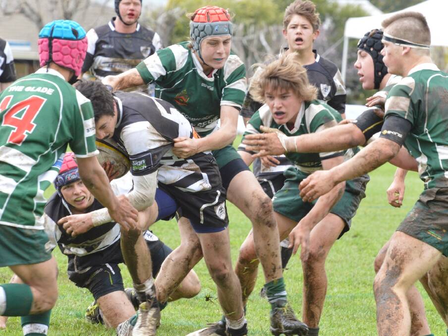 Teamwork: Tamworth's Sam Buster is swarmed by Barraba's Pat Sarungallo, Tom Latham, Taine Nash and Hagan Size during Saturday's grand final.