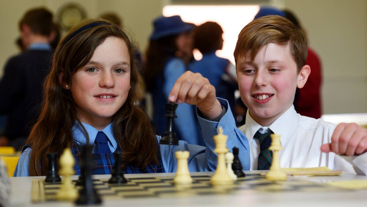 THINKING GAME: Timbumburi student Tiffany Allomes and Calrossy's Paul Sayad did battle on the chess board. Photo: Gareth Gardner 080917GGF15