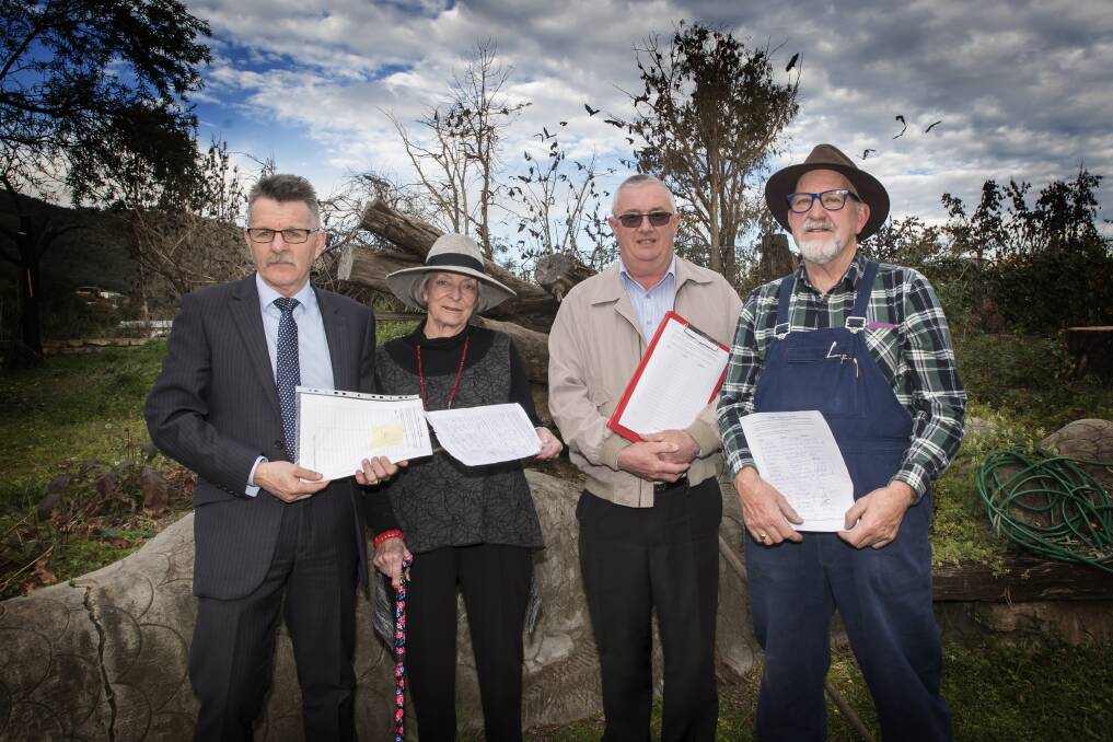 PEOPLE POWER: From left Craig Cox, Ruth Stuart, Jim Booth and Greg Clark calling for signatures on their petition. Photo: Peter Hardin 150817PHB019