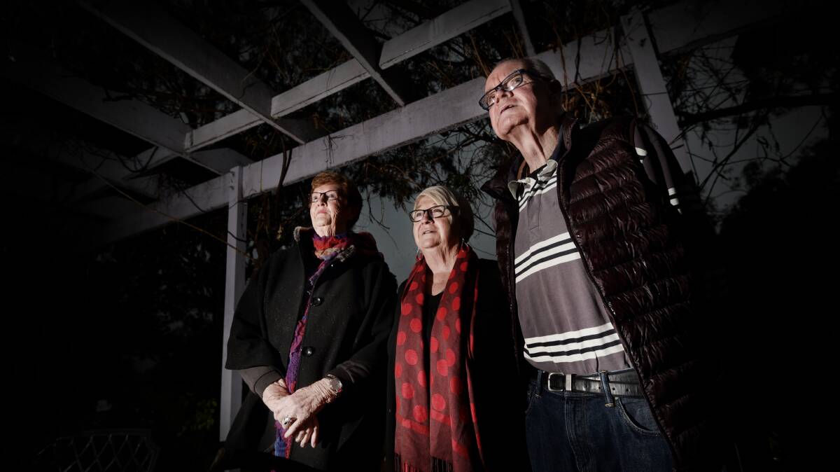 PEOPLE FIRST: Neighbour Agnes Riley with Lynne and Peter Prisk simply want the influx on flying foxes moved on from their homes. Photo: Gareth Gardner 280617GGA021