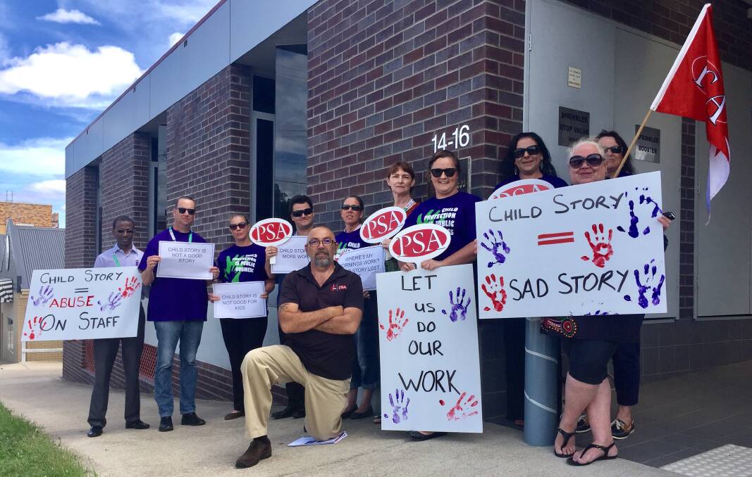NOT GOOD ENOUGH: Local FACS workers lead by PSA organiser Stephen Meares, kneeling, staged a lunch-time walk-off in protest to a new software system which has lost records of children. Photo: Jacob McArthur