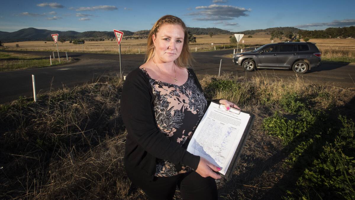 ROUND WE GO: Hills Plain resident Amanda Boyd with a petition calling for a roundabout on a troublesome intersection. Photo: Peter Hardin