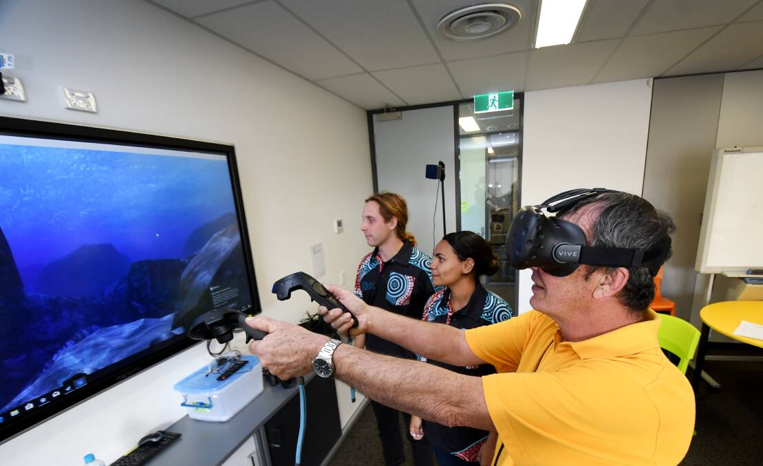 DIVING IN: Brad Sutherland goes for a virtual scuba-dive at The Youthie with Indigenous Digital Excellence facilitators Jethro Braico and Abigail Delaney during a week-long immersion in technology. Photo: Gareth Gardner 200618GGD004