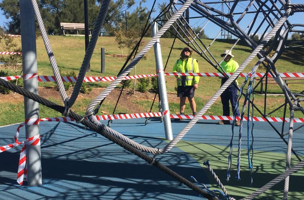 DAMAGE DONE: Council staff inspect vandalism caused at the playground last week. Photo: Jacob McArthur