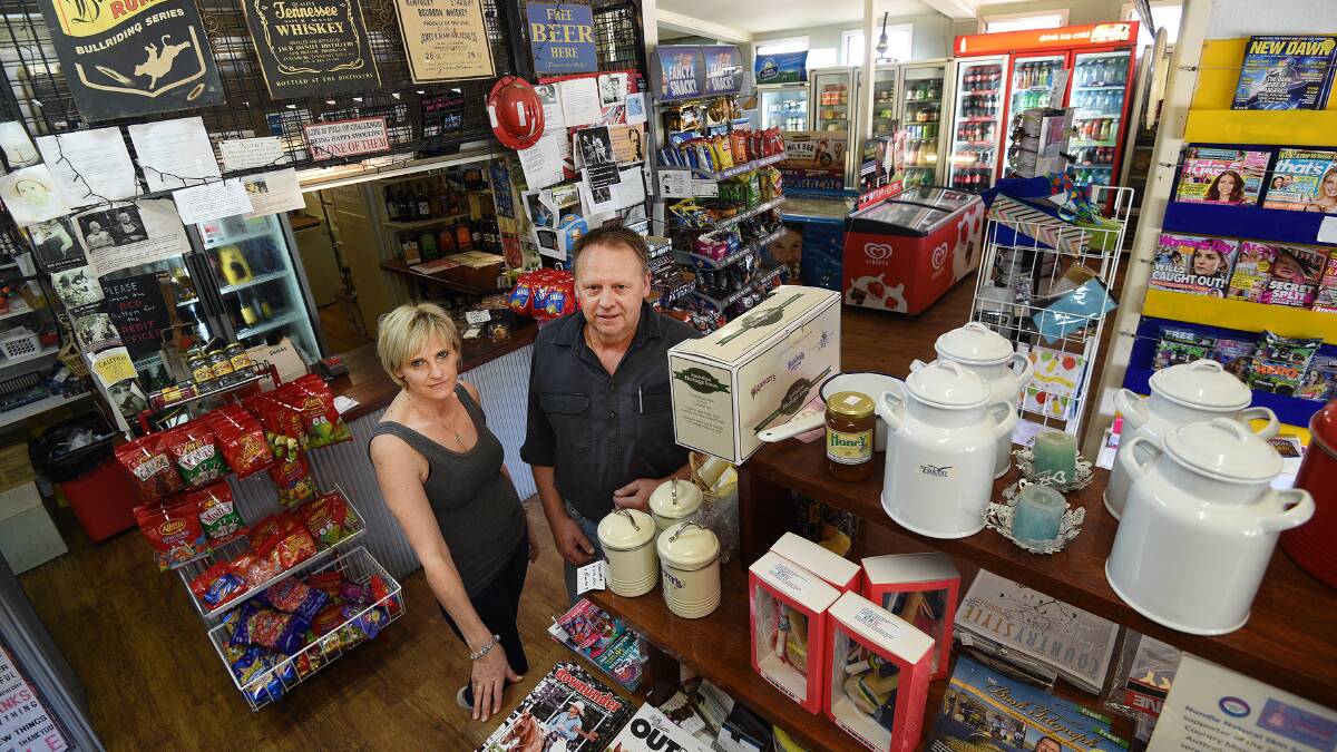 STILL CHUGGING ALONG: Kylie and Shane Douglas at the Woolomin store have been taking it week-by-week more than 12 months on from the fuel spill. Photo: Gareth Gardner 230317GGC01