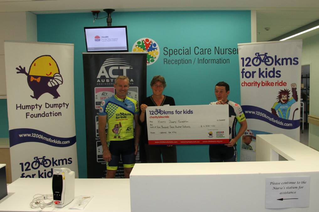 HANDOVER: Riders Leo Whiteley and Tim Bowring with hospital general manager Catharine Death. Photo: Supplied