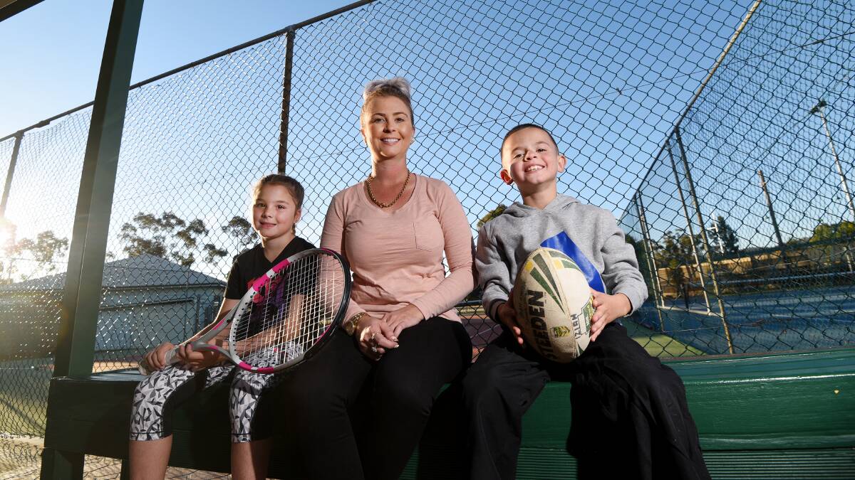 THIS SPORTING LIFE: Mother Hailey Craigie, flanked by Indyannah, 9, and Izaiah, 8, believes in keeping her kids active, but the costs of various sporting engagements do add up. Photo: Gareth Gardner 220617GGC03