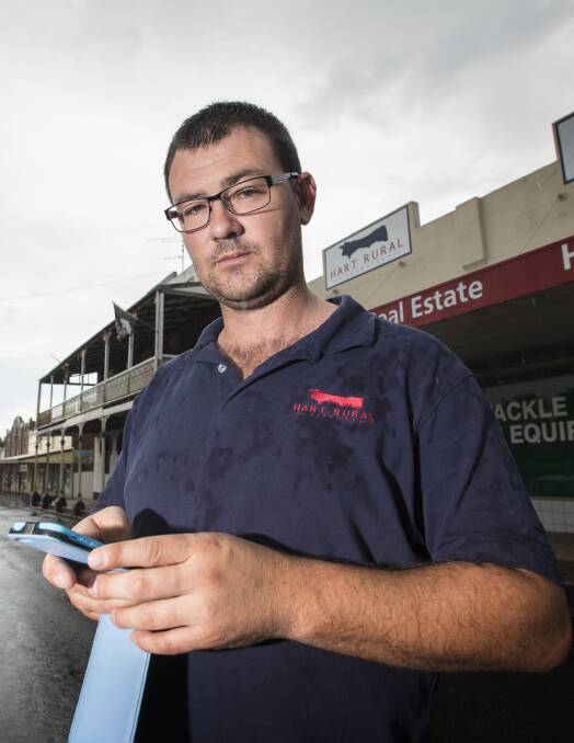 CALLING IN: Hart Rural manager Jacob Hawley had to drive to Attunga just to retrieve messages on his mobile phone. Photo: Peter Hardin 081216PHB037