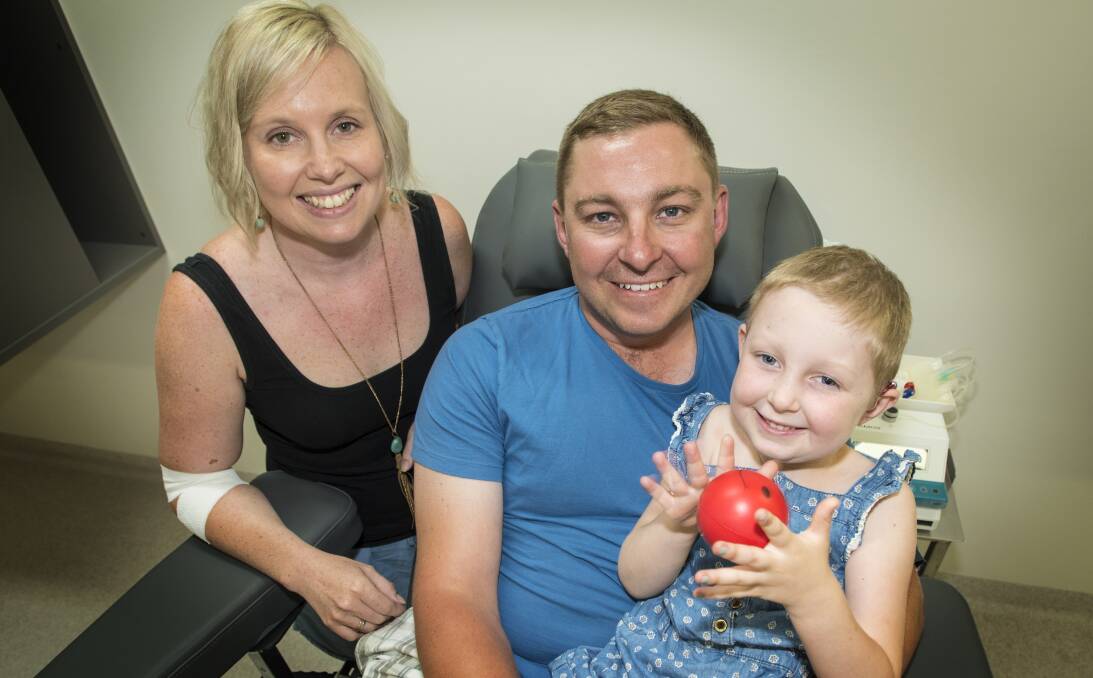 HOME AGAIN: Katie and Matt Brown with daughter Chloe, 5, are delighted to be spending Christmas at home following a huge health scare for their child earlier this year. Photo: Peter Hardin 201216PHD009