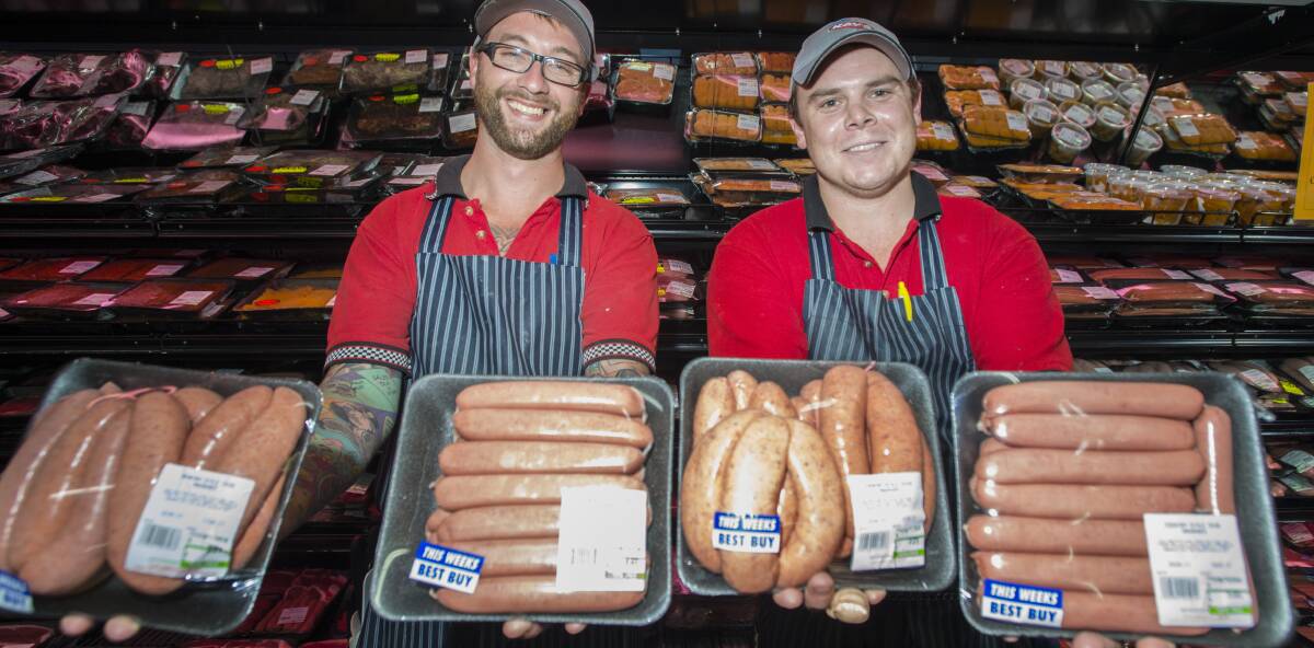 GET IN QUICK: Graham Walton and Sam Lucas with some highly sought after country music festival sausages. Photo: Peter Hardin 190117PHC009