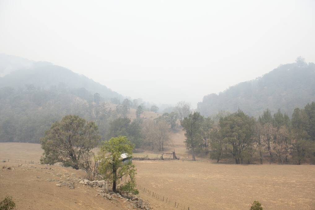 HAZY DAYS: There was a thick smog over Dungowan this weekend with fires burning around the dam. Photo: Peter Hardin 221219PHB012