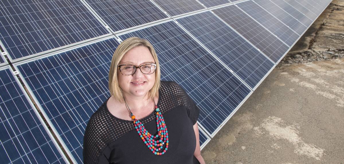 BRIGHT IDEA: Sustainability coordinator Tracey Carr with the solar array at the Swan St pump station. Photo: Peter Hardin 201216PHF026