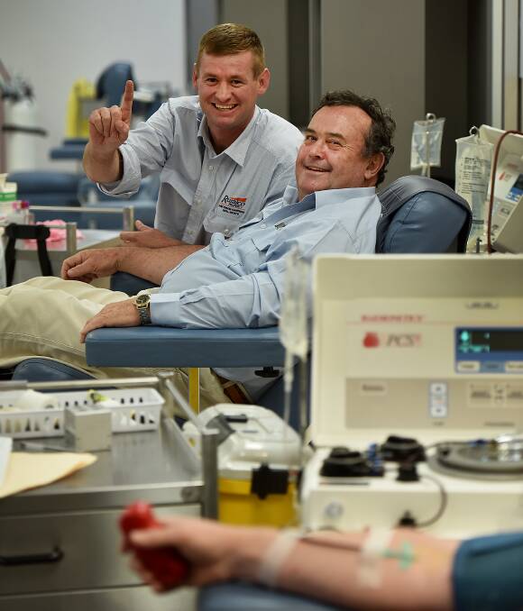 DONATING DUO: RuralCo Davidson and Cameron principal Daniel McCulloch (left) giving blood for the first time while fellow agent Scott Bray readies for his one-hundredth plasma donation. Photo: Gareth Gardner 250816GGC02