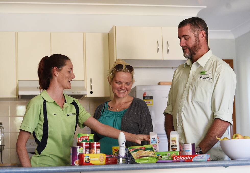 SPECIAL DELIVERY: Leigh Wagstaff (left) and Brett Goodchild delivered care packages to Tamworth Family Support Service clients on Youth Homelessness Matters Day. Photo: Gareth Gardner 050417GGB04
