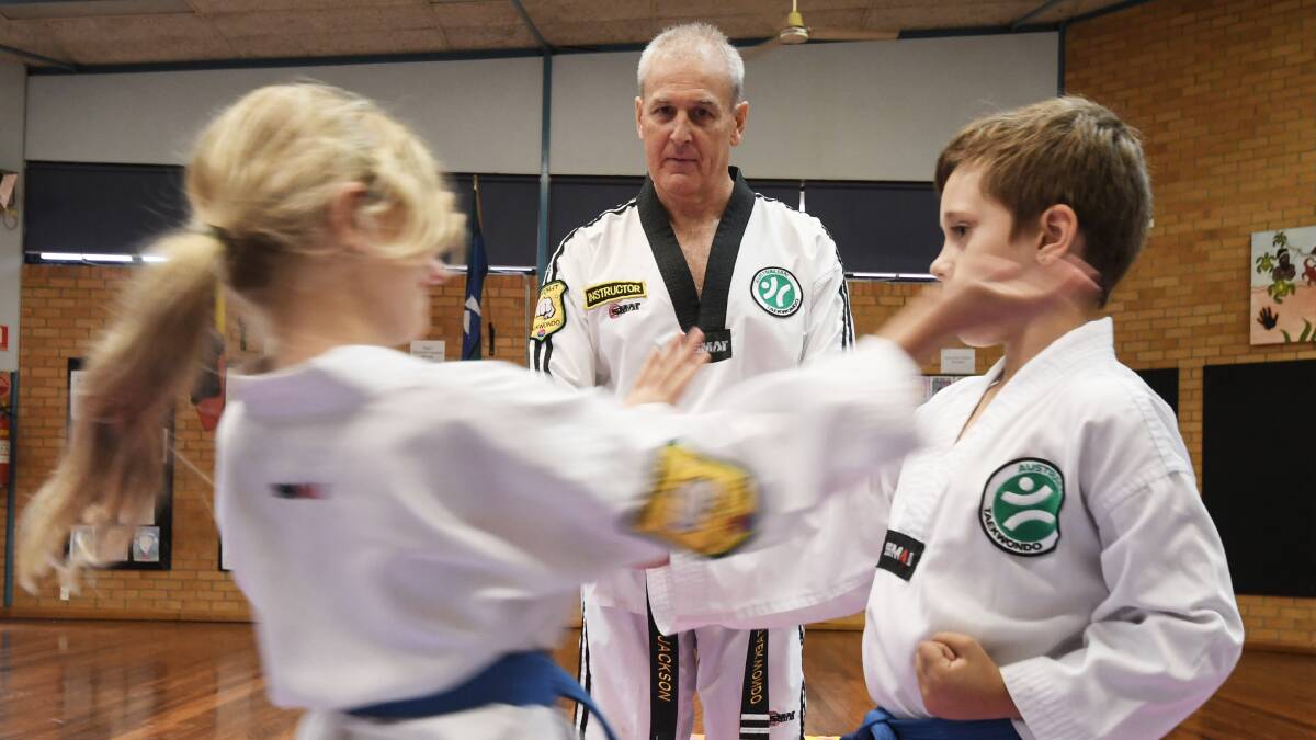 FIGHTING BACK: Taekwondo instructor David Jackson with some younger students ahead of White Ribbon Day. Photo: Gareth Gardner 211118GGC07