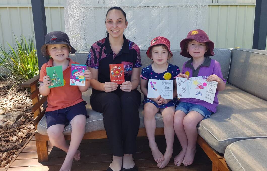ON THE CARDS: Ashleigh Walton with Calala Goodstart kids, Noah, Annabel and Phoebe, writing Christmas cards for Tamworth nursing home residents. Photo: Supplied