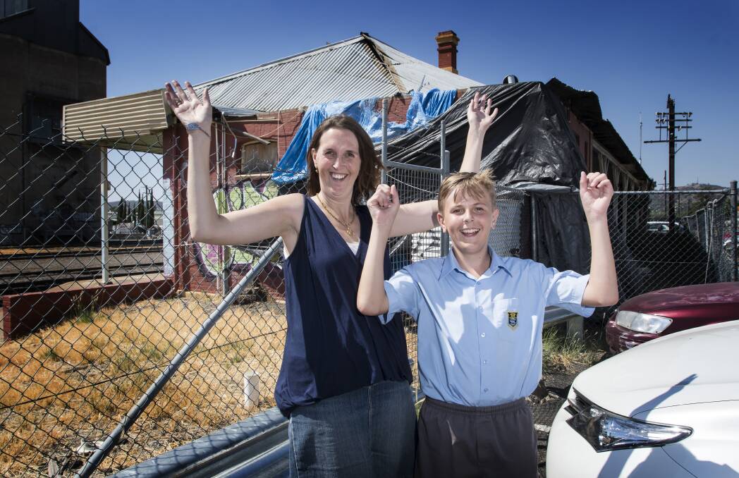 FIX FOR FUTURE: Melinda Gill says a restored version of the now dilapidated West Tamworth train station would be an asset for her son Alex and future generations. Photo: Peter Hardin 150218PHB013