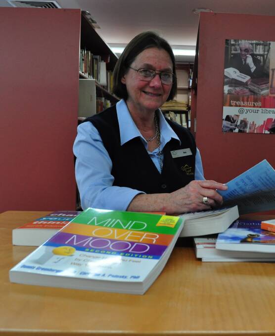 Orange technical services librarian Rosalind Dorsman with some of the Books on Prescription collection, an important program to promote key wellness messages.
