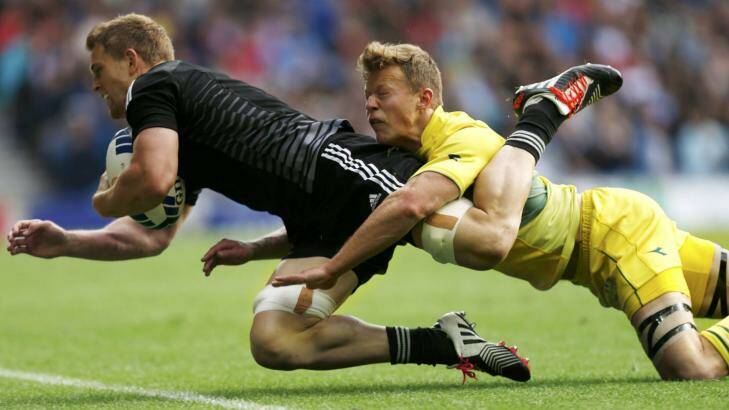 New Zealand's Bryce Heem beats the tackle of Australia's Cameron Clark to score during the men's Rugby Sevens semi-final at the Commonwealth Games in Glasgow. Photo: Russell Cheyne