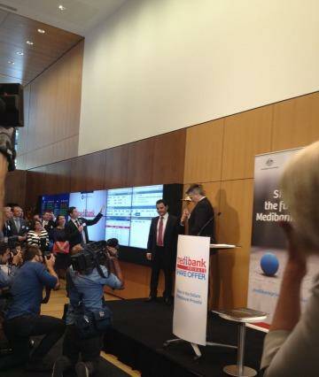 Medibank Private chief George Savvides and Finance Minister Mathias Cormann ring the bell to send the stock live. Photo: ASX