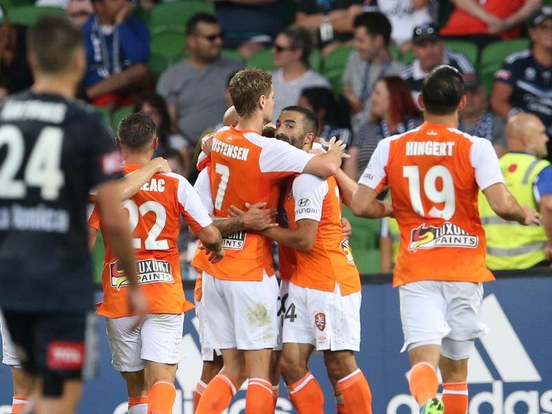 Goals to Massimo Maccarone and Brett Holman have given Brisbane an upset win over Melbourne Victory.
