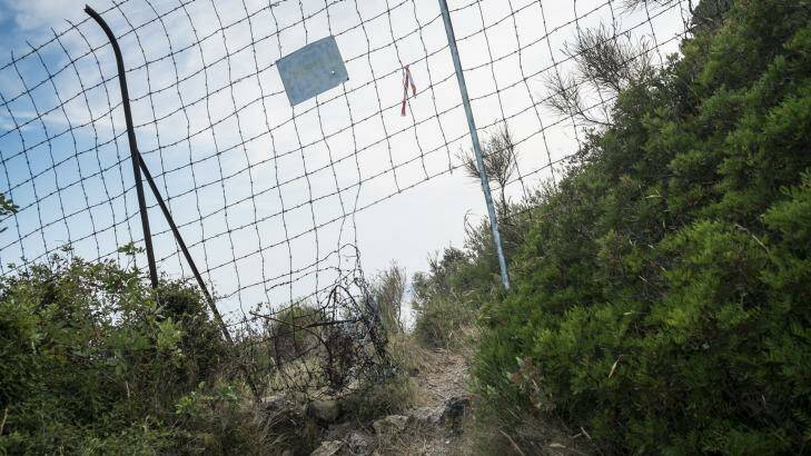A hole in the fence at the border beckons refugees from sub-Saharan Africa trying to get from Italy to France.  Photo: Marco Panzetti
