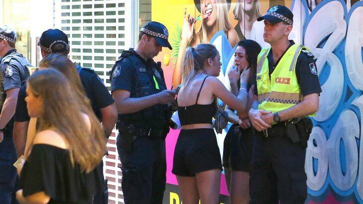 Thrills and spills: A girl in tears is consoled by her friend on the Gold Coast. Photo: Aaron Wallender