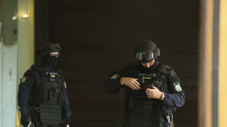 Public order and riot squad police walk out of the  Downing Centre
courts building on Liverpool street in Sydney 

 Photo: Kate Geraghty
