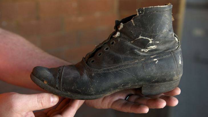The boot was uncovered behind the fireplace at Children's Court in Surry Hills, more than a century after it was hidden.
 Photo: Steven Siewert