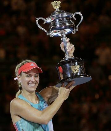 Angelique Kerber of Germany holds the trophy aloft after defeating Serena Williams of the United States in the women's singles final at the Australian Open tennis championships in Melbourne, Australia, Saturday, Jan. 30, 2016.(AP Photo/Aaron Favila) Photo: Aaron Favila