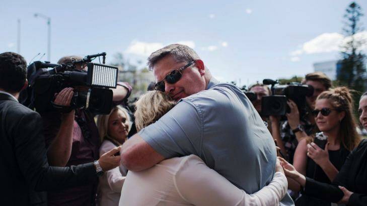 Peter and Rebecca McNeill hug after a jury found their son's killers guilty of his murder in October. Photo: Christopher Pearce
