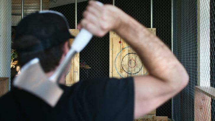 Adam Schilling, co-owner of Maniax, gets ready to throw an axe at one of the targets. Photo: Tony Walters