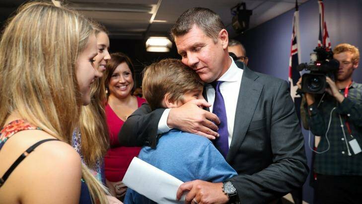 Premier Mike Baird embraces his family after Thursday's press conference where he announced his resignation. Photo: Janie Barrett