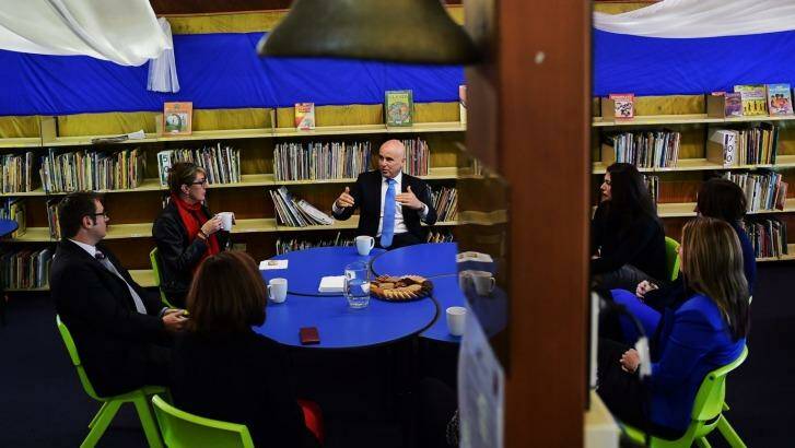 Education Minister Adrian Piccoli speaks to the principal and teachers at Villawood North Public School amid concerns about funding.
 Photo: Nick Moir