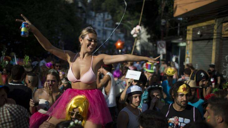 A reveler enjoys the "Ceu na Terra", or Heaven on earth, block party during Carnival celebrations in Rio de Janeiro, Brazil, Saturday, Feb. 6, 2016. Rio de Janeiro's over-the-top Carnival is the highlight of the year for many local residents. Hundreds of thousands of merrymakers are taking to the streets in hundreds of open-air "bloco" parties. (AP Photo/Leo Correa) Photo: Leo Correa