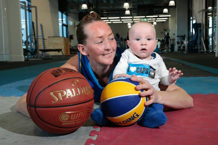 Sport.  Canberra Capitals player Michelle Cosier with 5 month old son Levi at the University of Canberra Sporting Commons. Michelle will be making a comeback with the Capitals after a year off to become a mum and playing netball with the ACT Darters.  14 August 2014. Canberra Times photo by Jeffrey Chan.