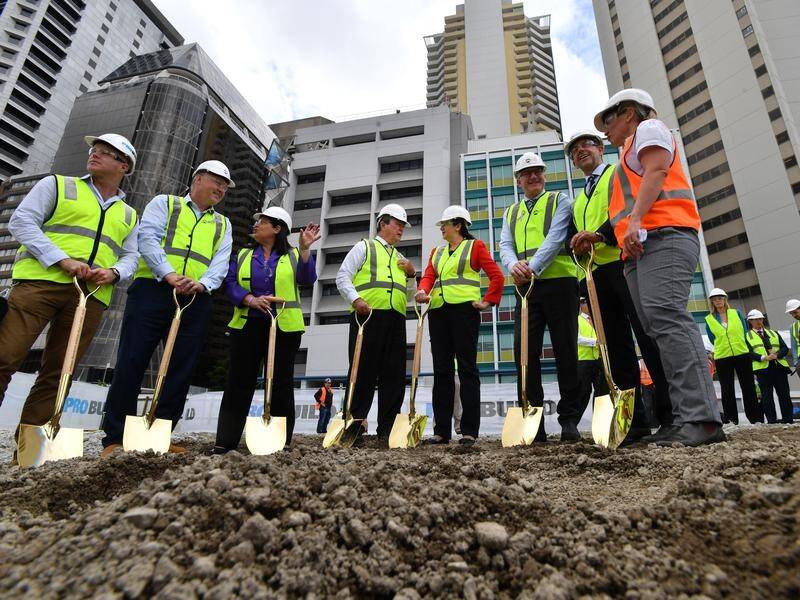 Annastacia Palaszczuk, 4th from right, has turned the first sod on the Queen's Wharf project.