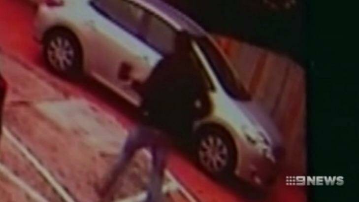 A man, alleged to be the attacker, was shown on CCTV carrying an axe shortly before the stabbing. Photo: Nine News