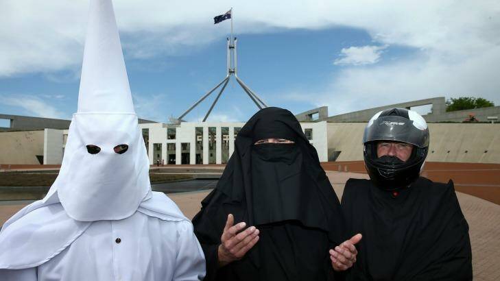 Three men cover their faces to protest the wearing of the burqa in public places. Photo: Alex Ellinghausen