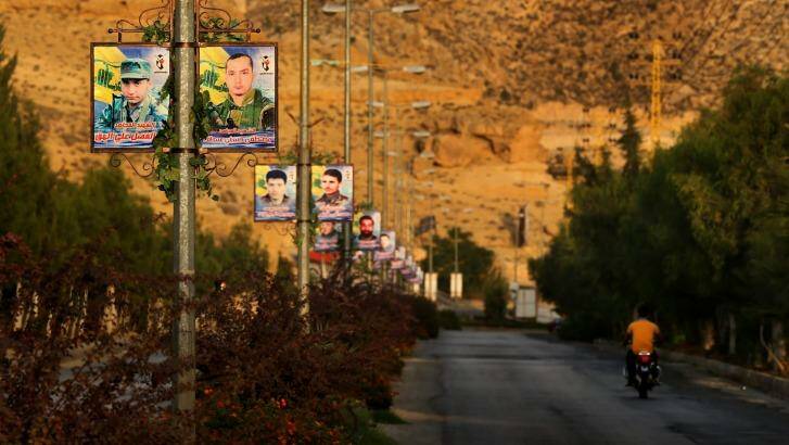Overrun: Posters of dozens of Hezbollah fighters killed fighting in Syria against IS line the road entering Hermel village in the Bekaa Valley, Lebanon. Photo: Kate Geraghty