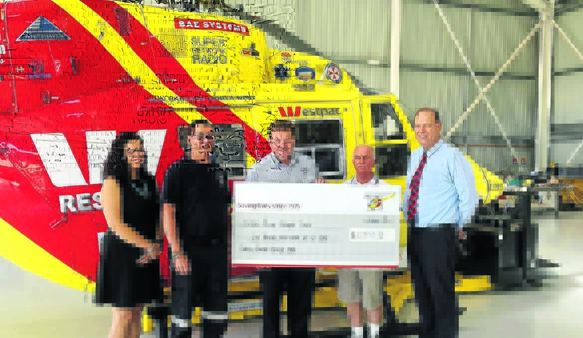 The Westpac Rescue Helicopter Service s Taylor Fletcher and pilot Dave Davies receive a cheque from Calrossy Anglican School s combined P&F chairman Stuart Watts, head of primary Robert Black and head of secondary boys Joe Goldsworthy.