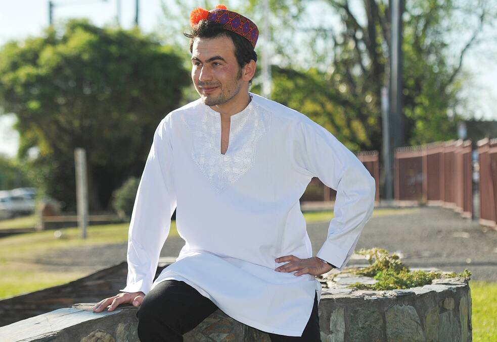 NEW HOME: Hazara refugee Karar Hussain escaped terrorism in Pakistan and now lives in Tamworth. He is pictured here wearing traditional Hazara clothing  kolay qaptumar (the hat) and peroni kasheeda (the tunic). Photo: Geoff O Neill 240914GOI01